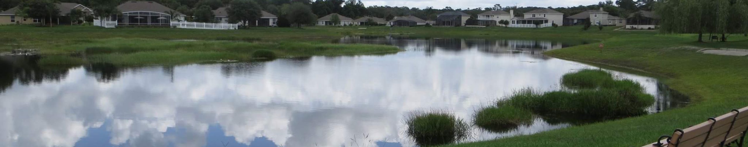 bench overlooking pond in Crystal Cove community