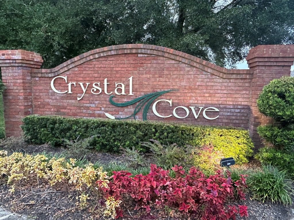 brick front entrance gate reading Crystal Cove